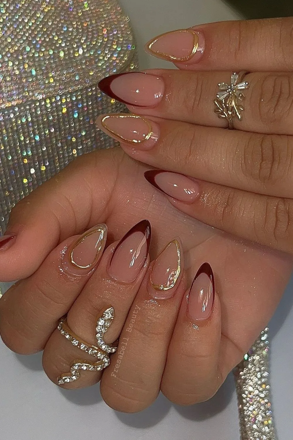 French tip nails with gold chrome accents