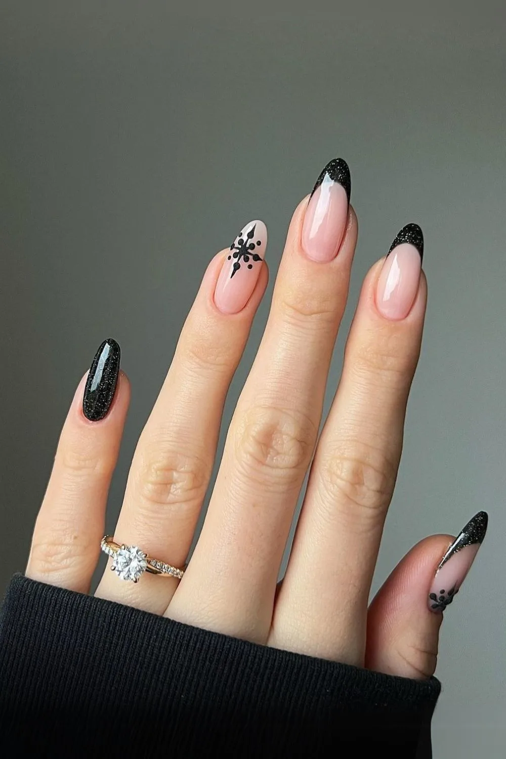 Glittery black French mani with snowflakes