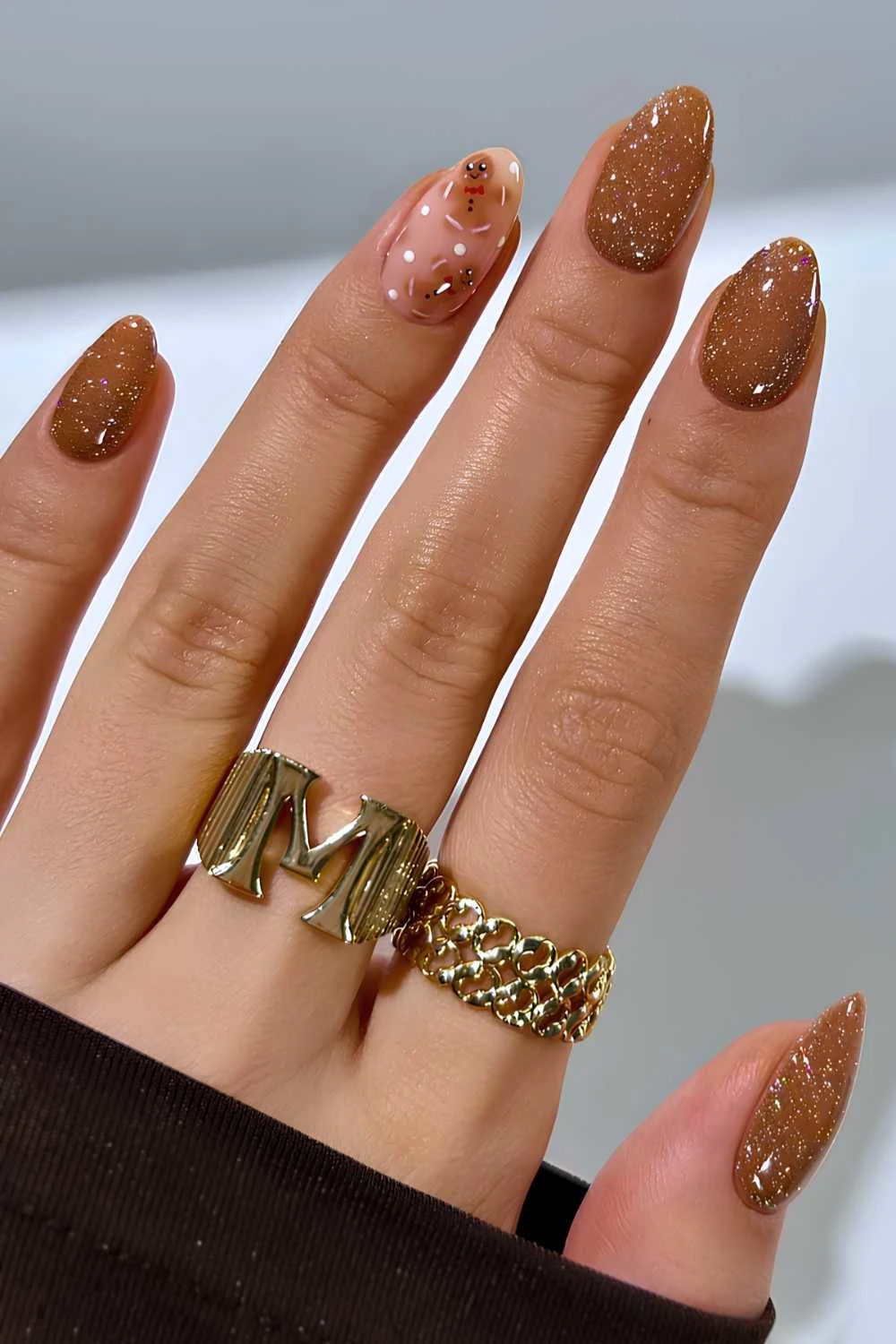 Glittery brown nails with gingerbread cookie art