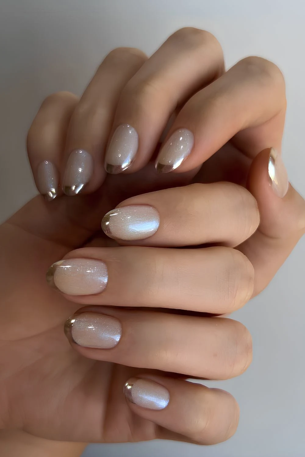 Glittery white mani with accent gold tips
