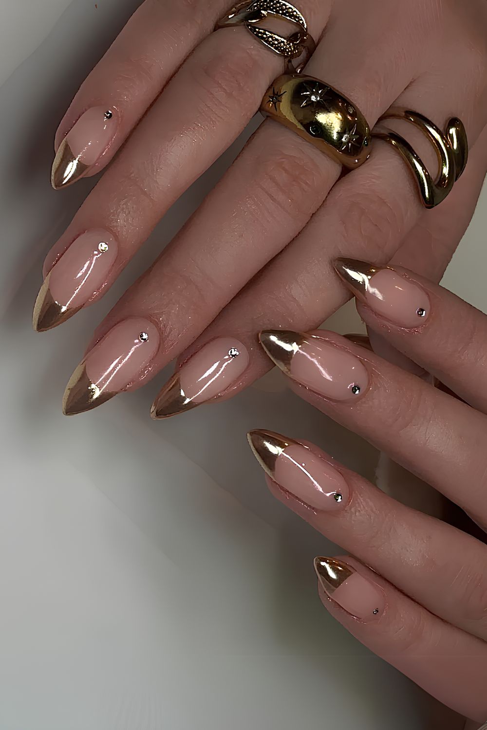 Gold French nails with rhinestone accent