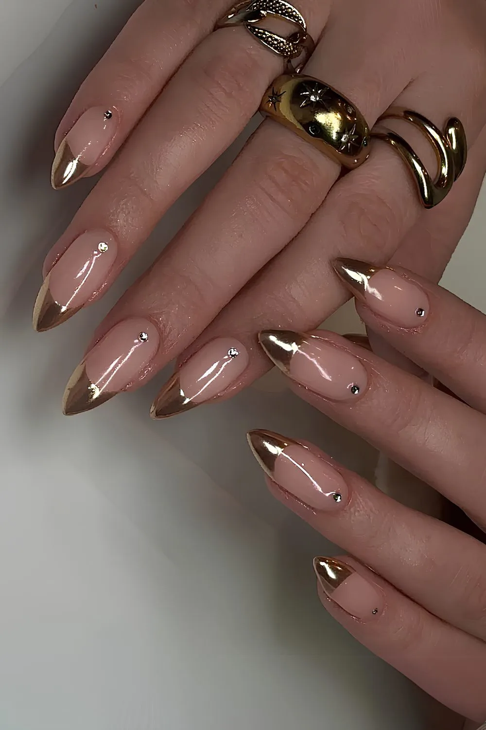 Gold French nails with rhinestone accent