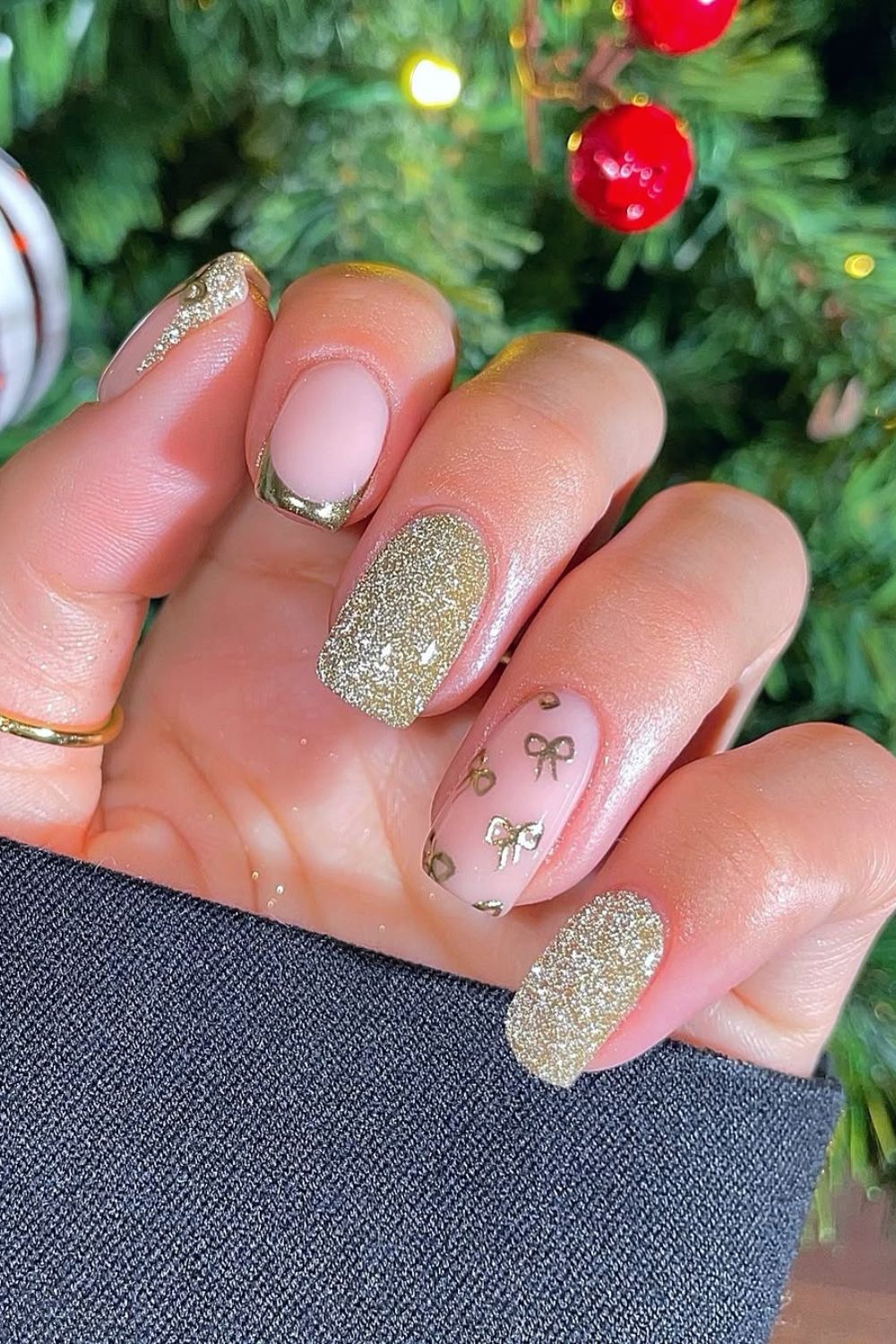 Gold French tip nails with gold glitter and bows