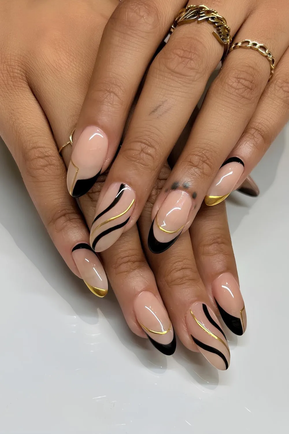 Gold and black nails with swirls