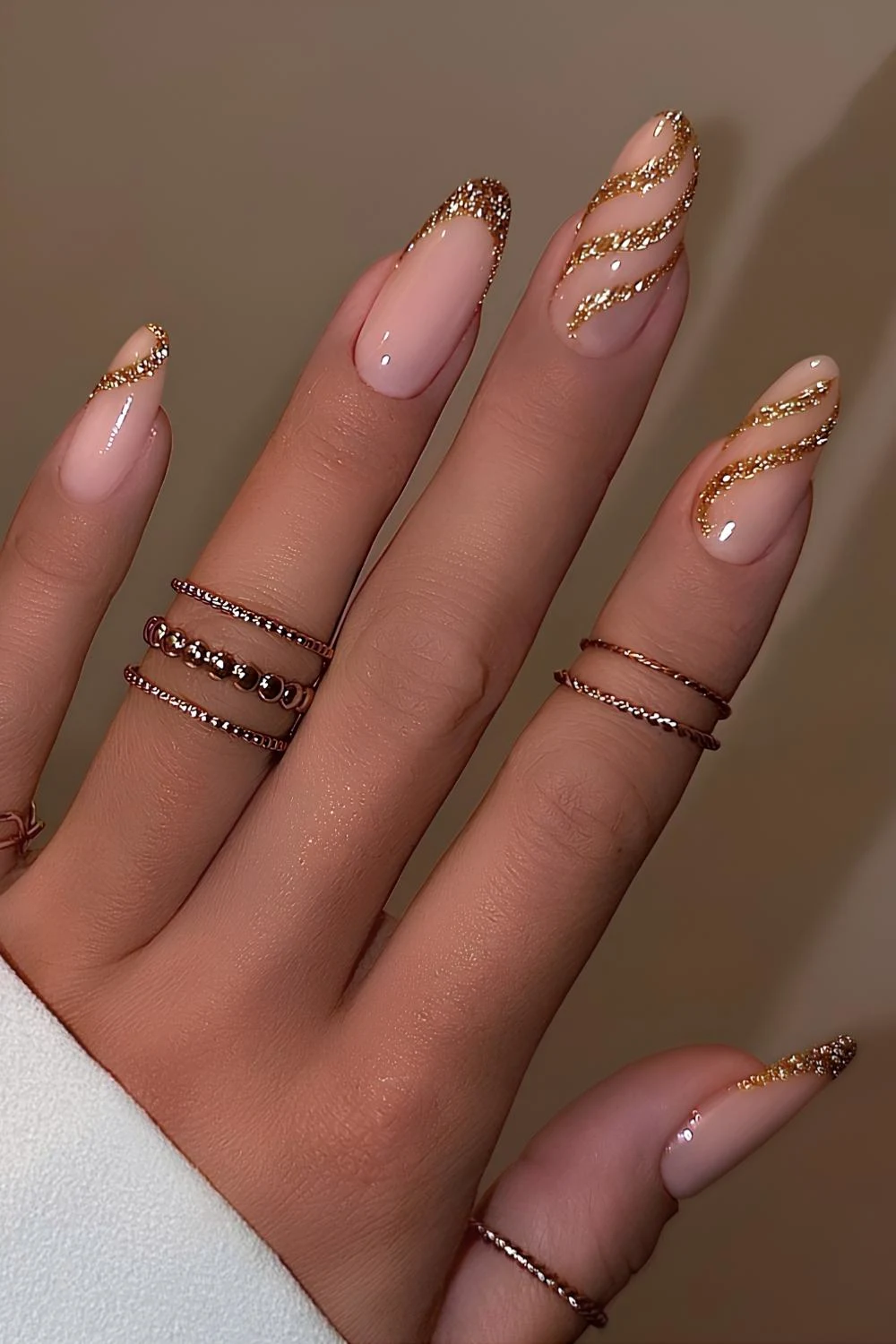 Gold glitter French mani with accent swirls