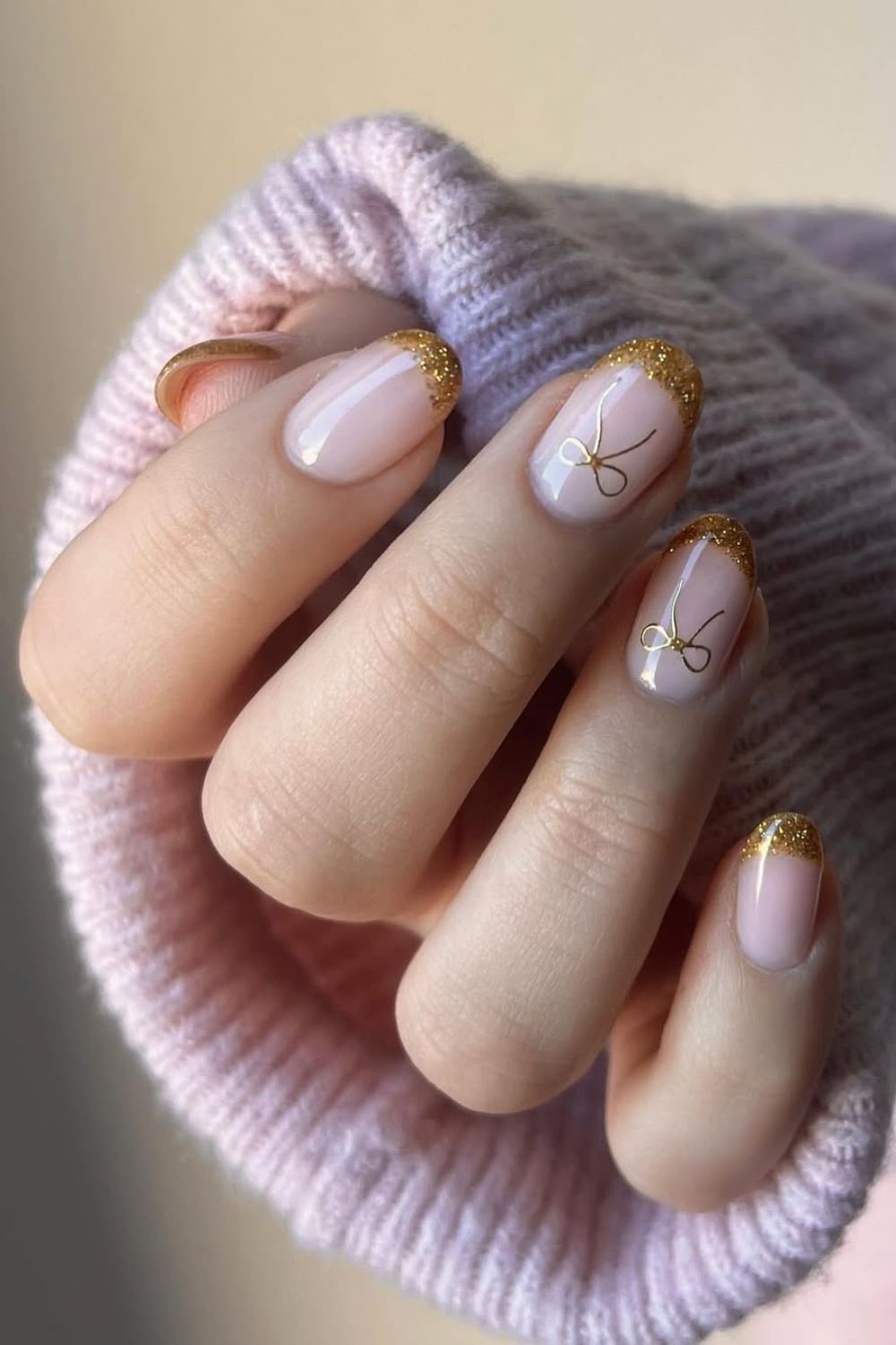 Gold glitter French tip nails with bows