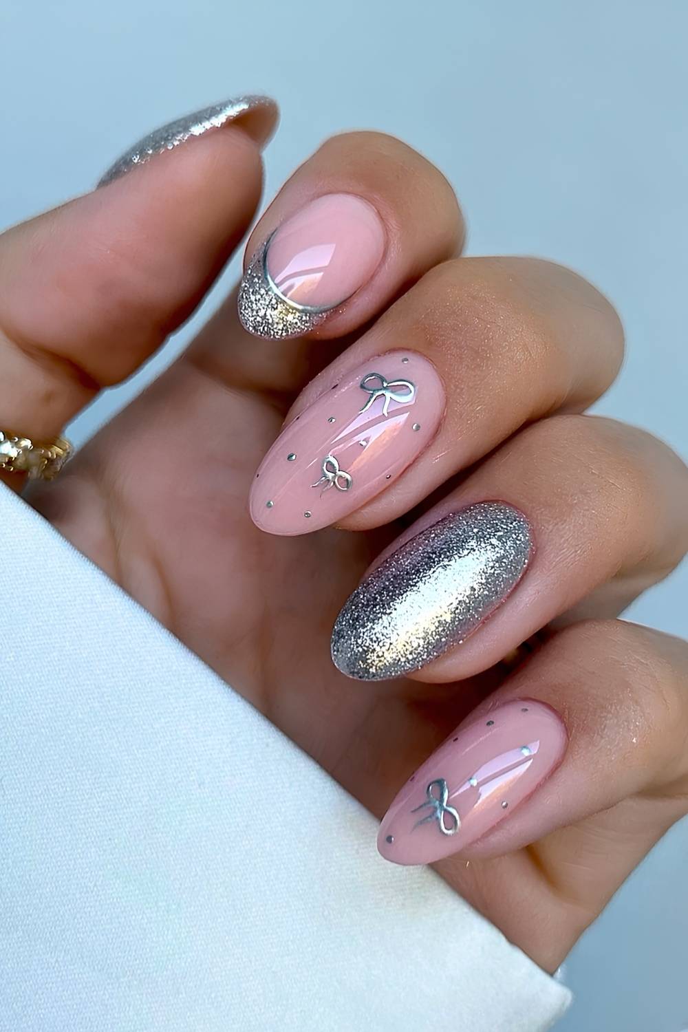 Gold glitter manicure with micro bow art