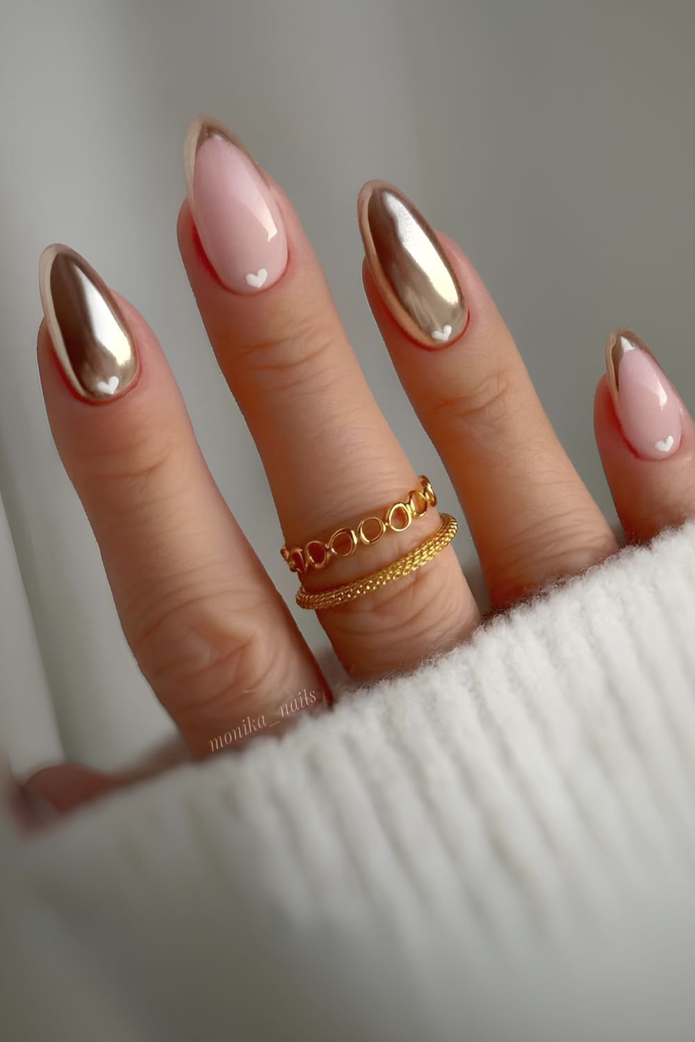 Gold nails with accent hearts and French tips