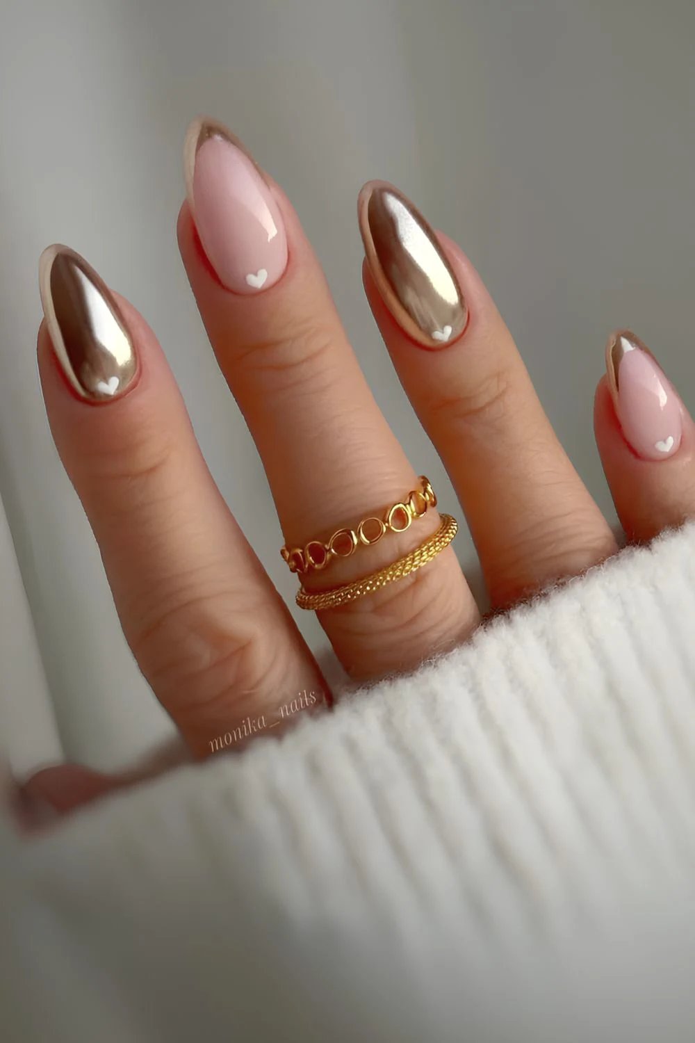 Gold nails with accent hearts and French tips