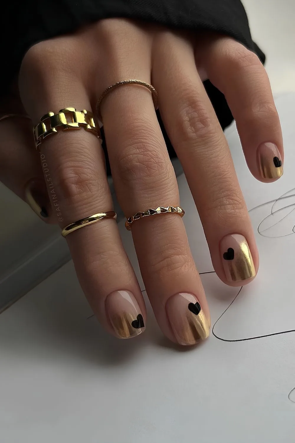 Gold ombre mani with black heart accents