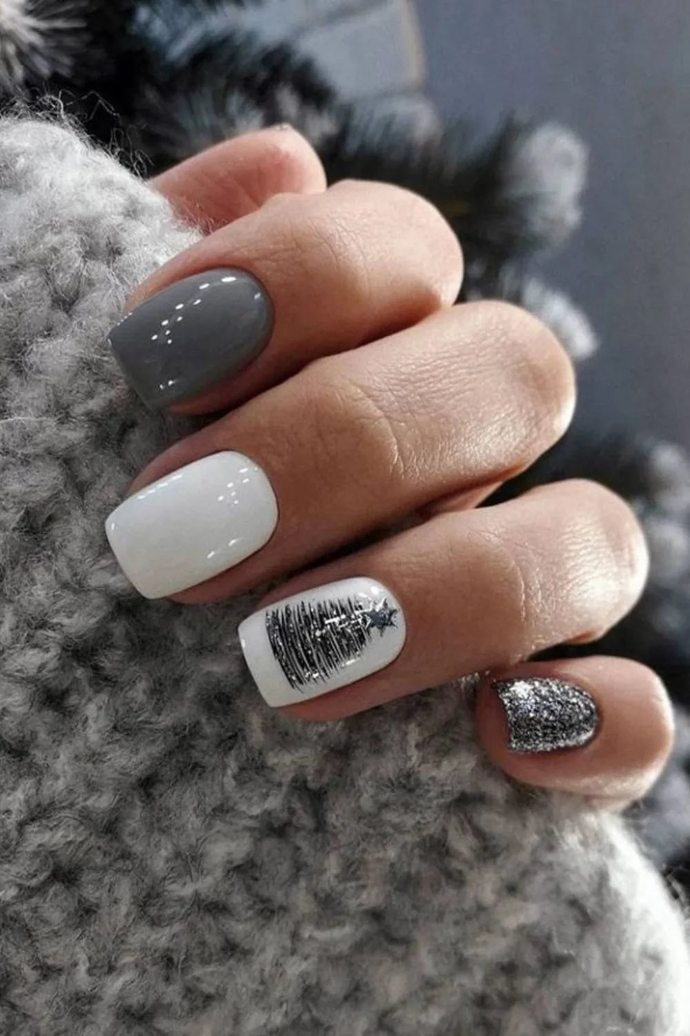 Gray and white nails with silver glitter and Christmas tree accent