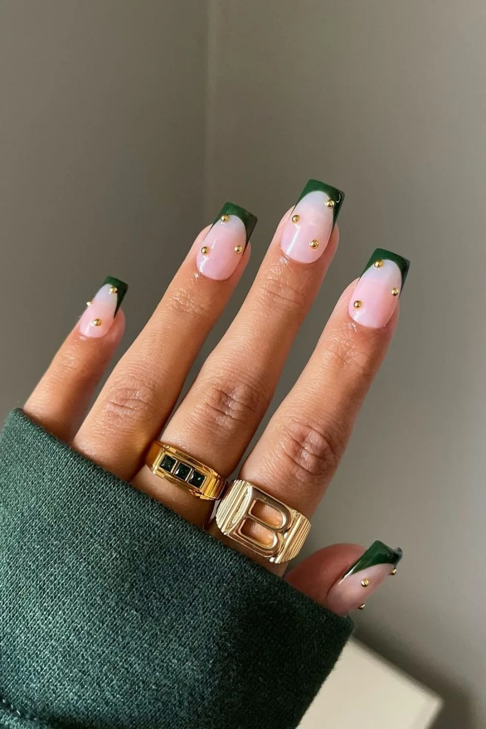 Green French tip nails with gold pearl accents