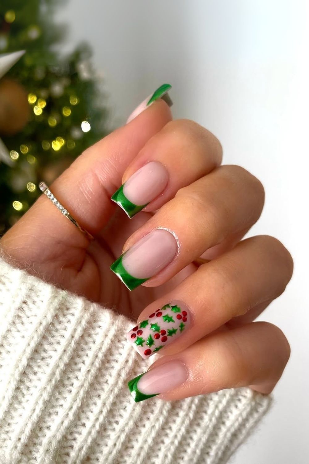 Green French tip nails with holly berry accents