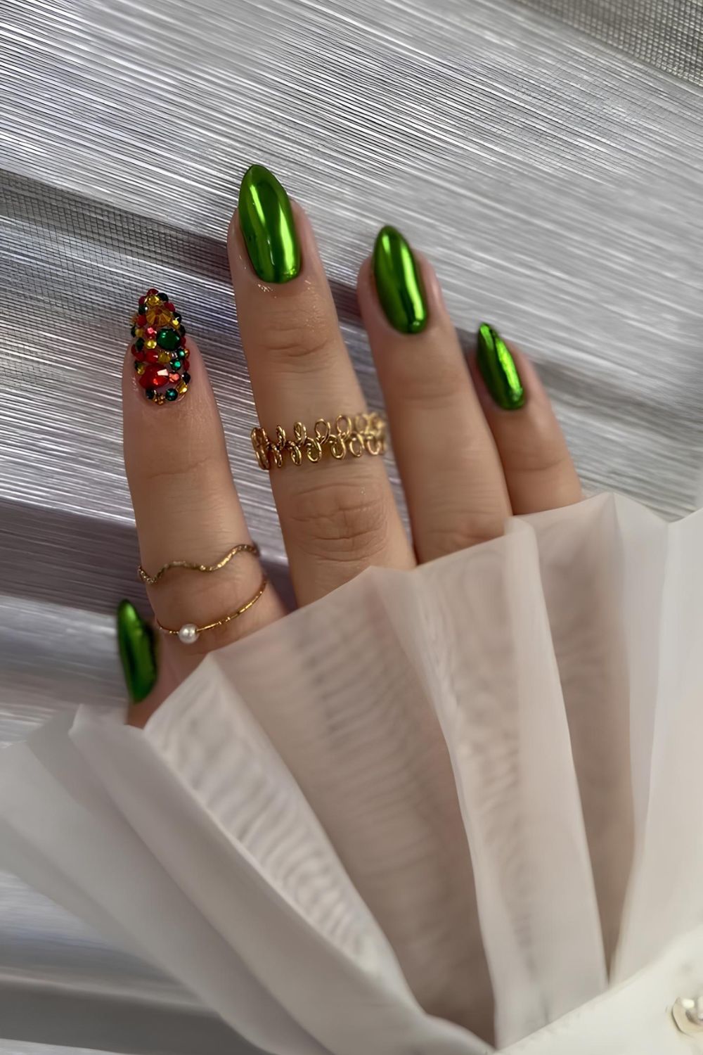 Green chrome nails with colorful rhinestones