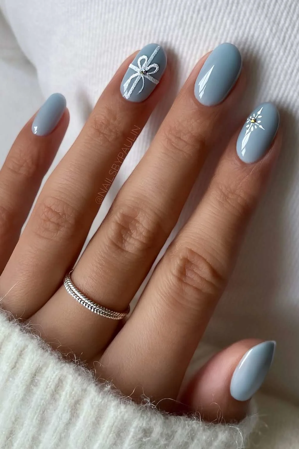 Icy blue nails with gift bow art accents