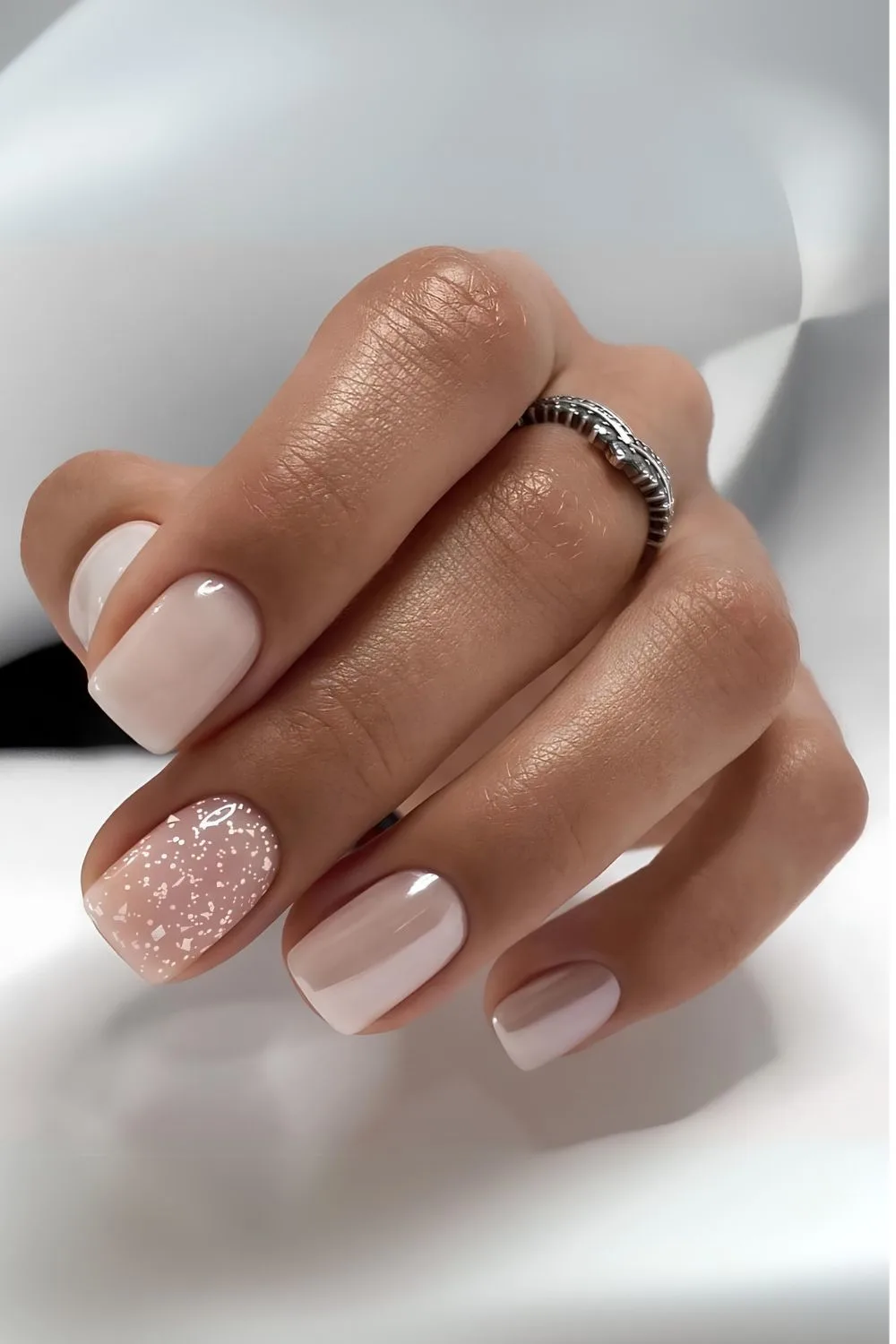 Icy pink chrome nails with snow art accent