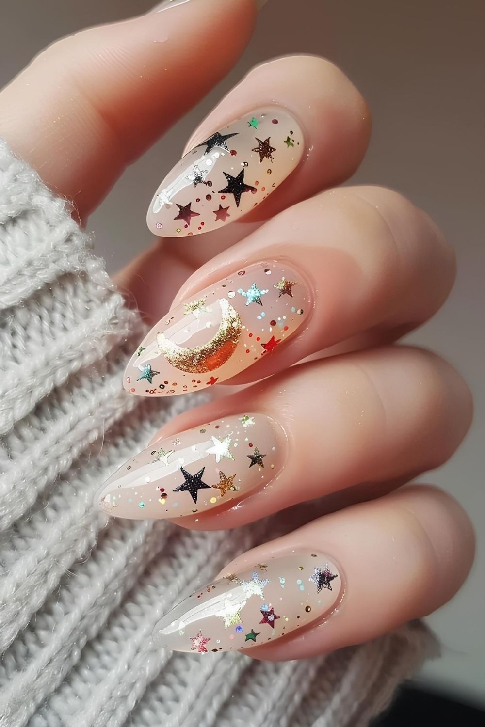 Jelly neutral nails with gold stars and confetti accents