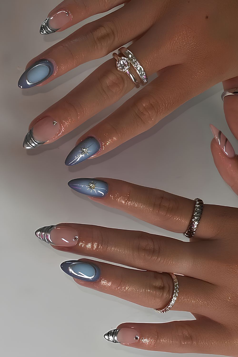 Light blue aura nails with silver chrome accents