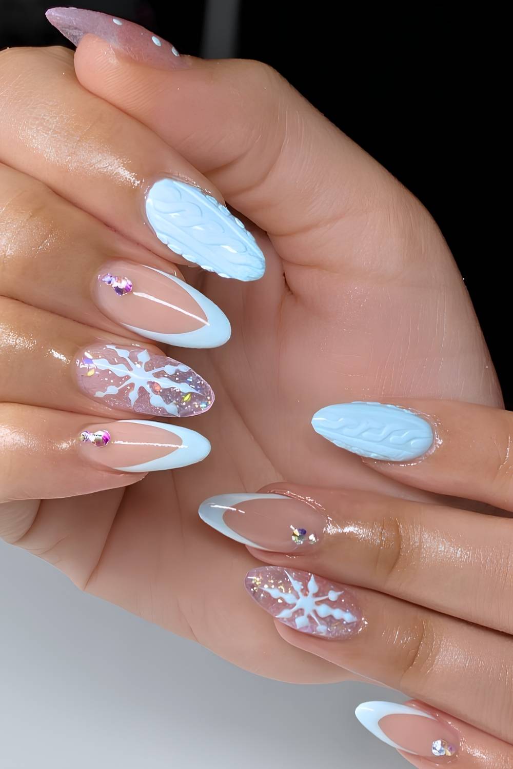 Light blue nails with snowflakes and gems