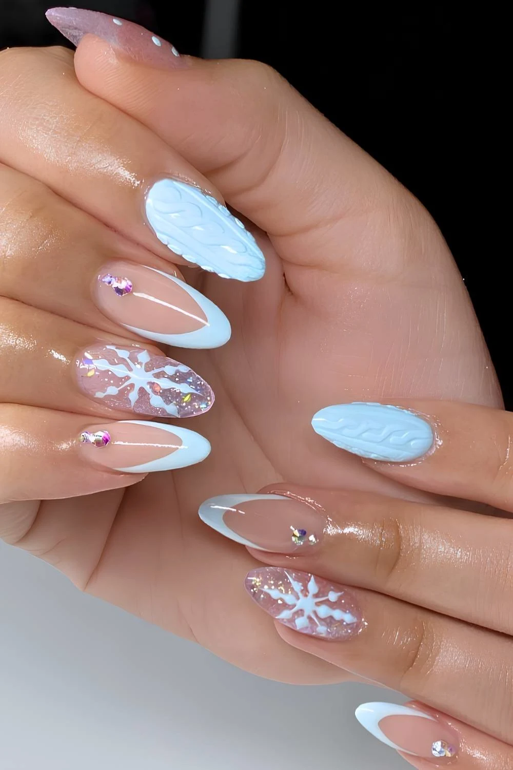 Light blue nails with snowflakes and gems