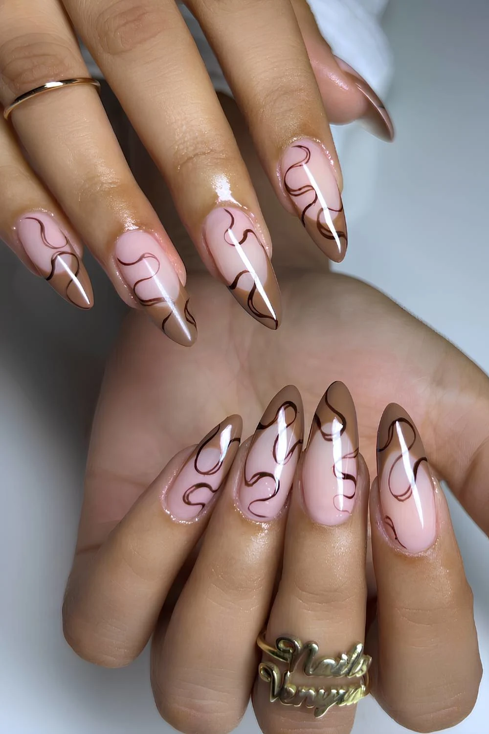 Light brown French nails with swirl art