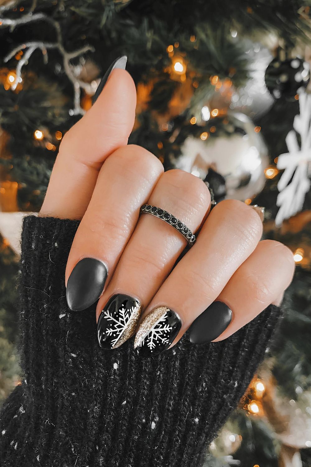 Matte black nails with snowflakes and glitter