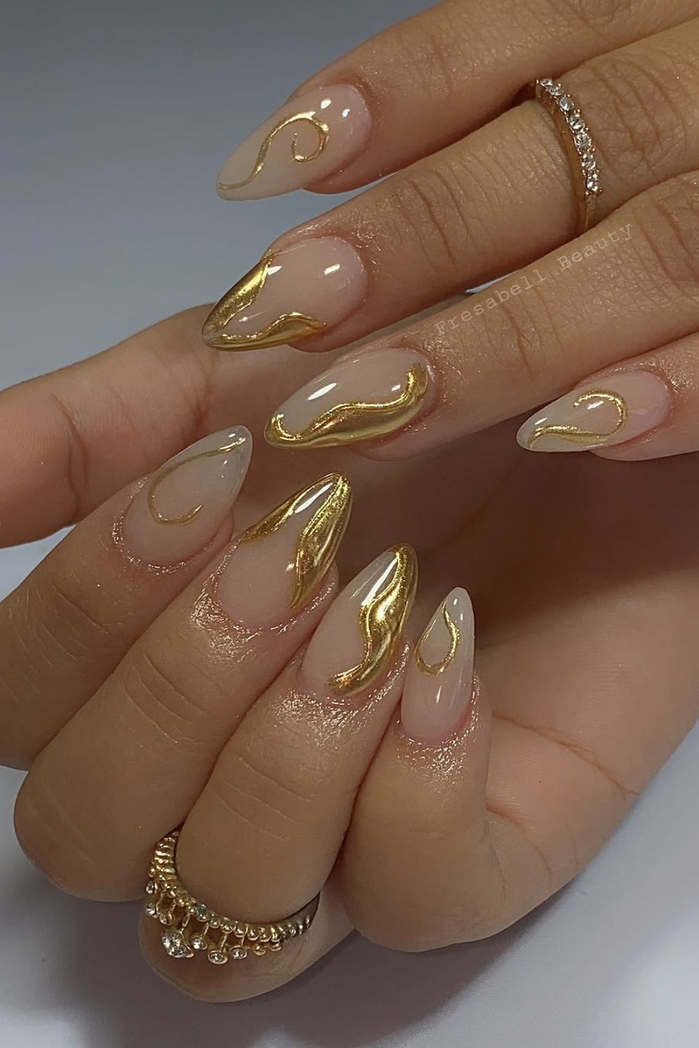 Metallic gold swirly French tip nails