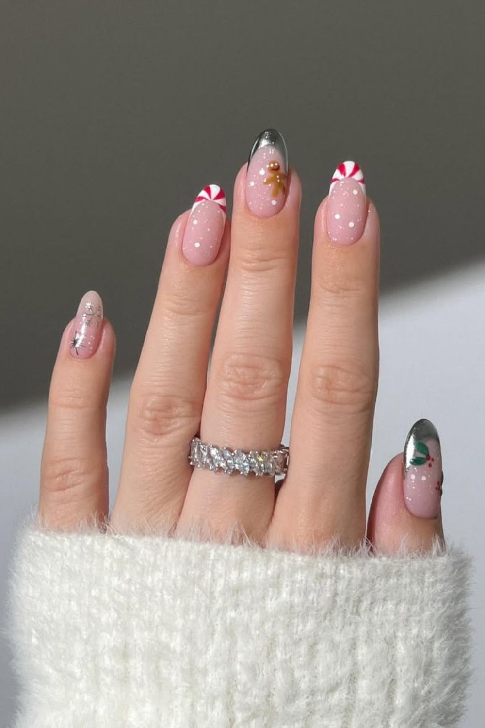 Metallic silver and candy cane pattern French tips with one gingerbread cookie accent