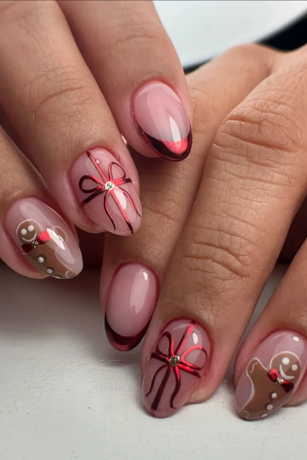 Mettalic red French tip nails with bow and gingerbread accent