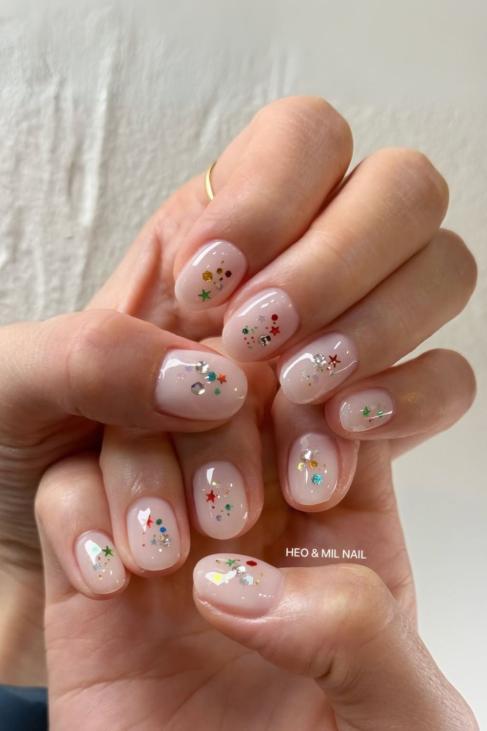 Milky nails with colorful glitter