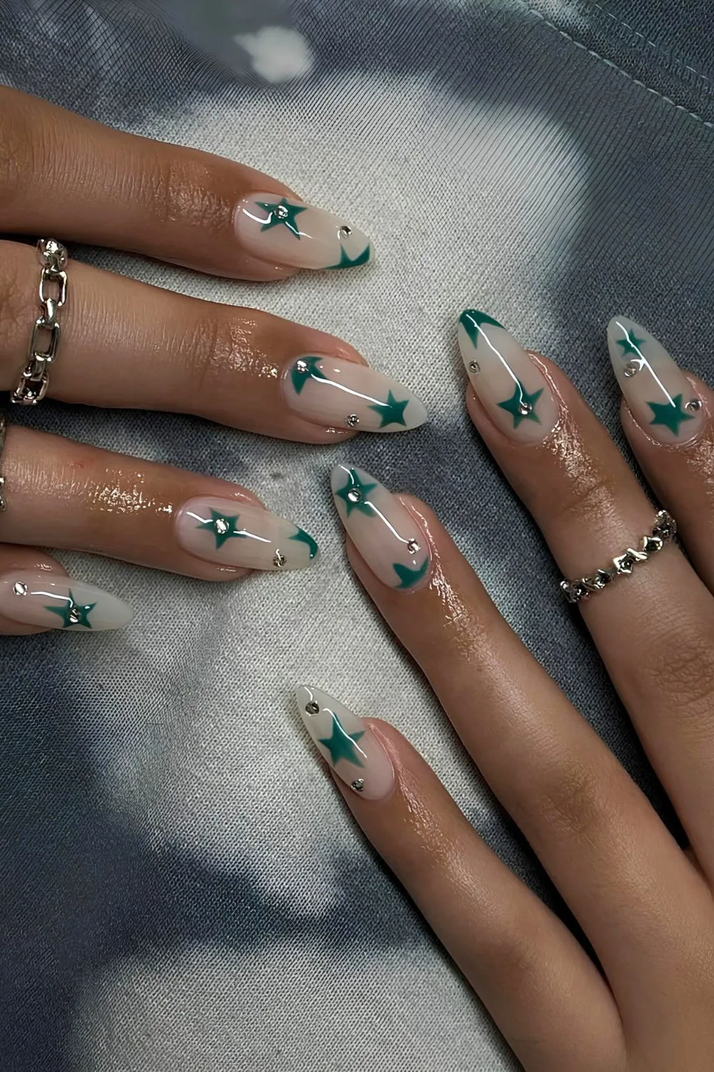 Milky nails with green stars and rhinestones