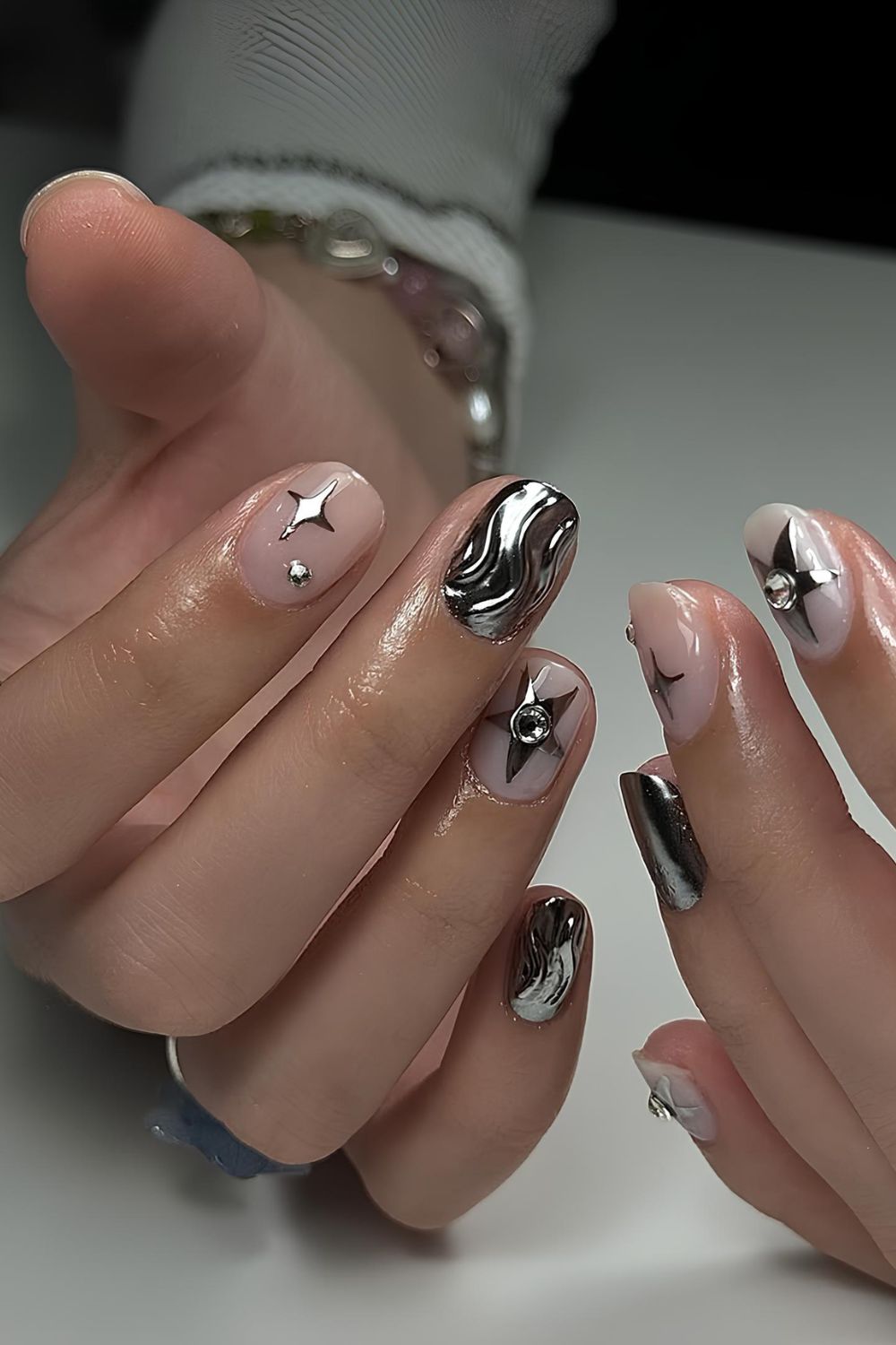 Milky nails with silver chrome stars