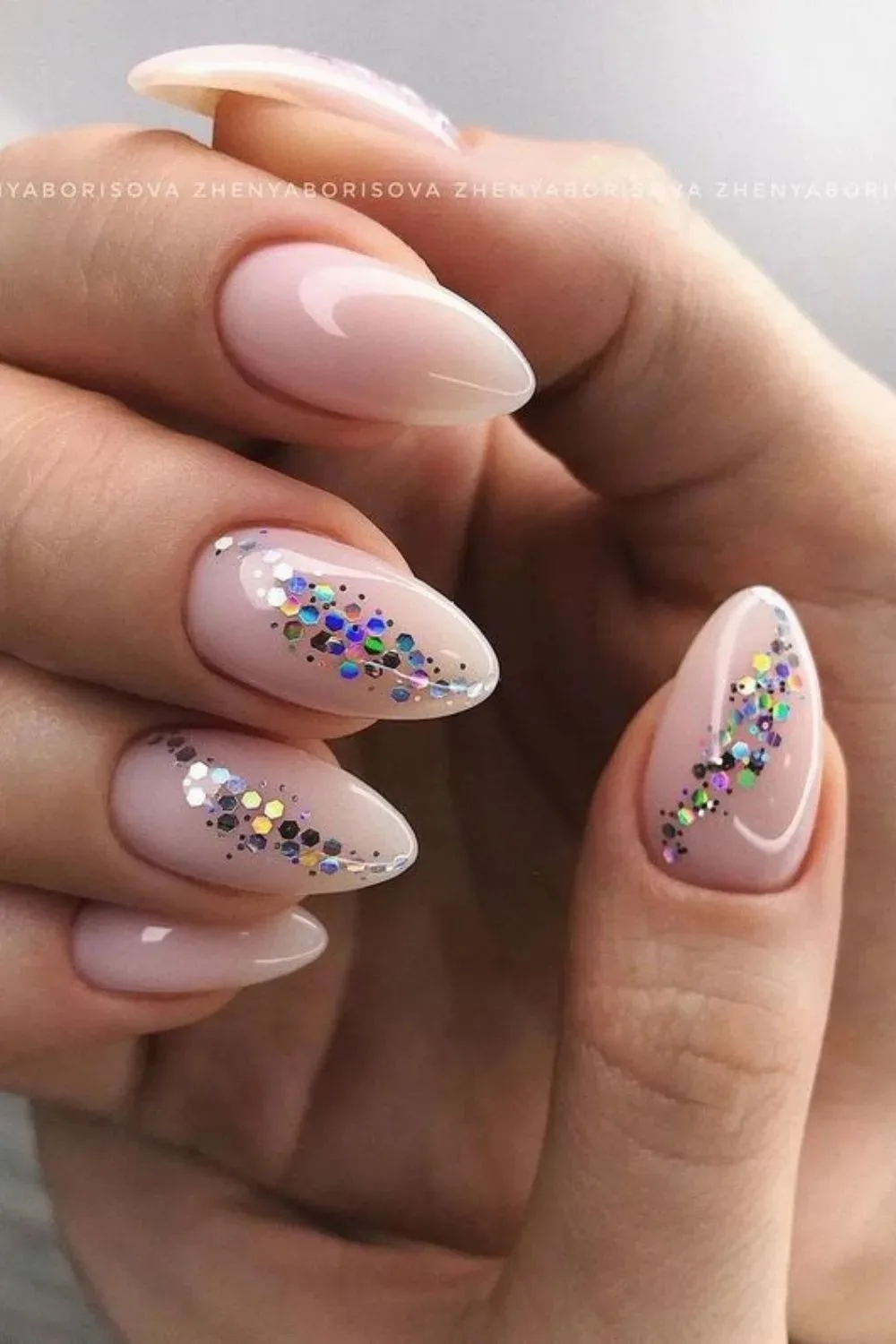 Milky pink nails with glitter accents