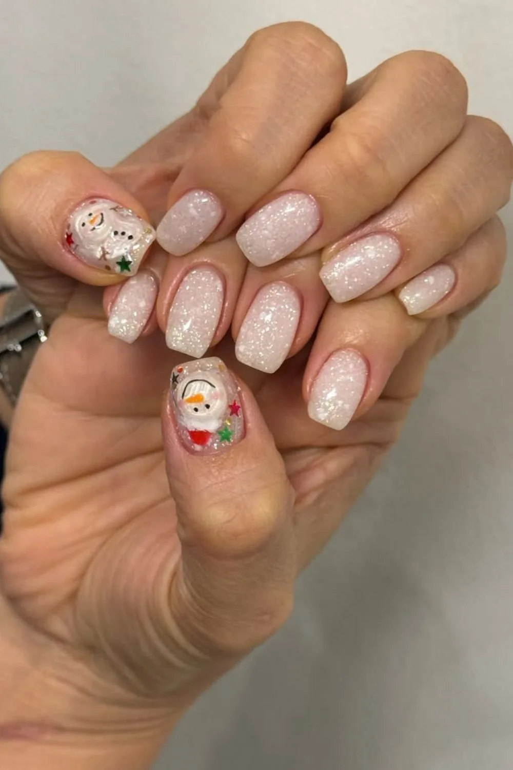 Milky white glitter nails with snowman accent