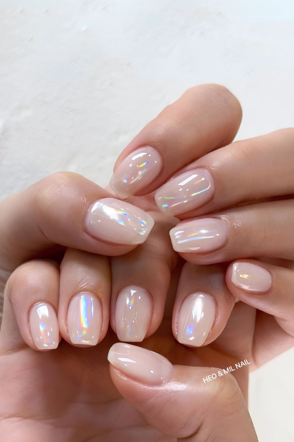 Milky white nails with aurora chrome finish