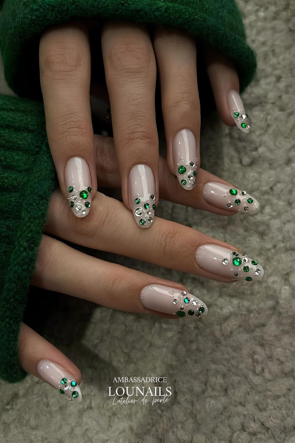 Milky white nails with green rhinestones