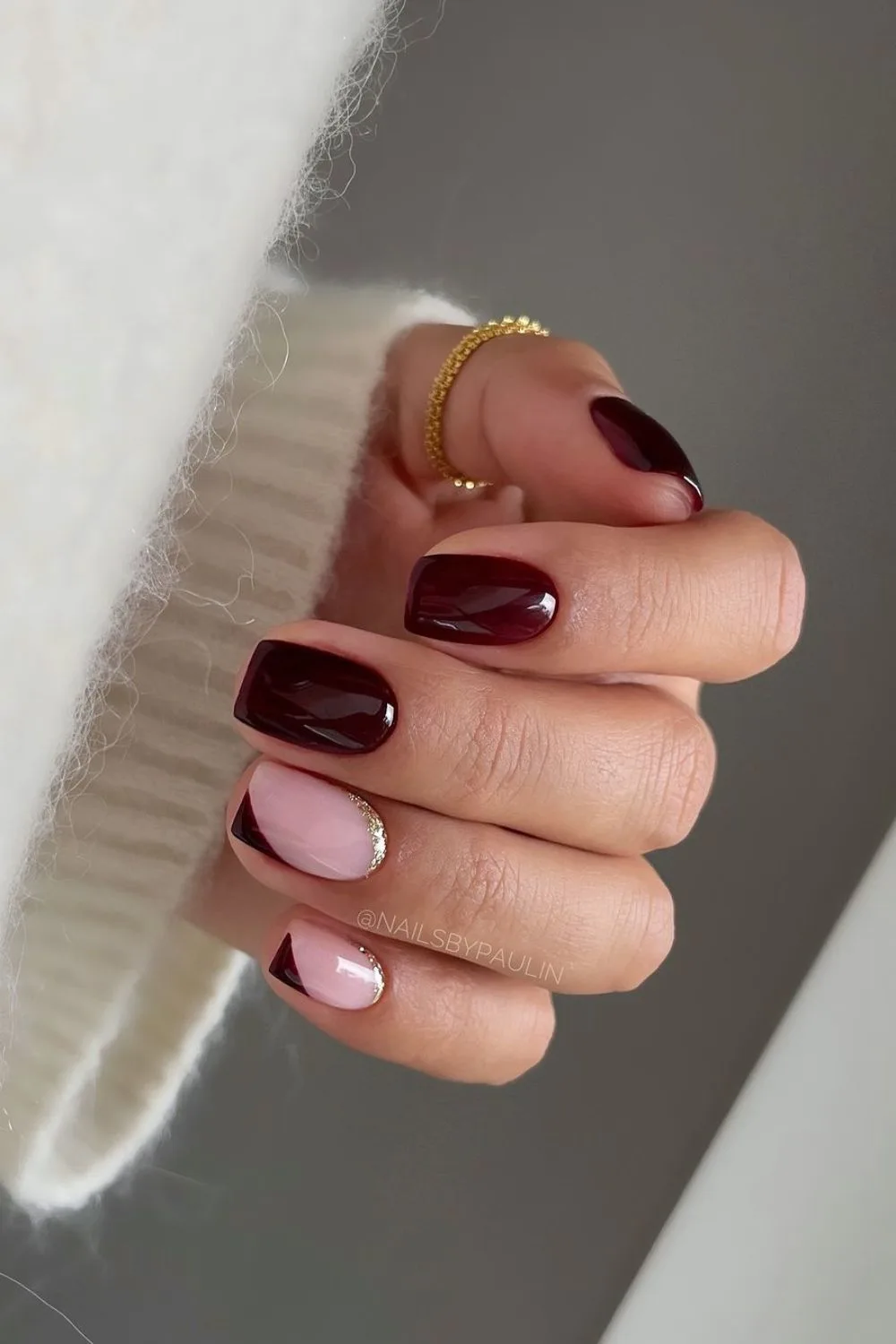 Moody burgundy nails with gold accents