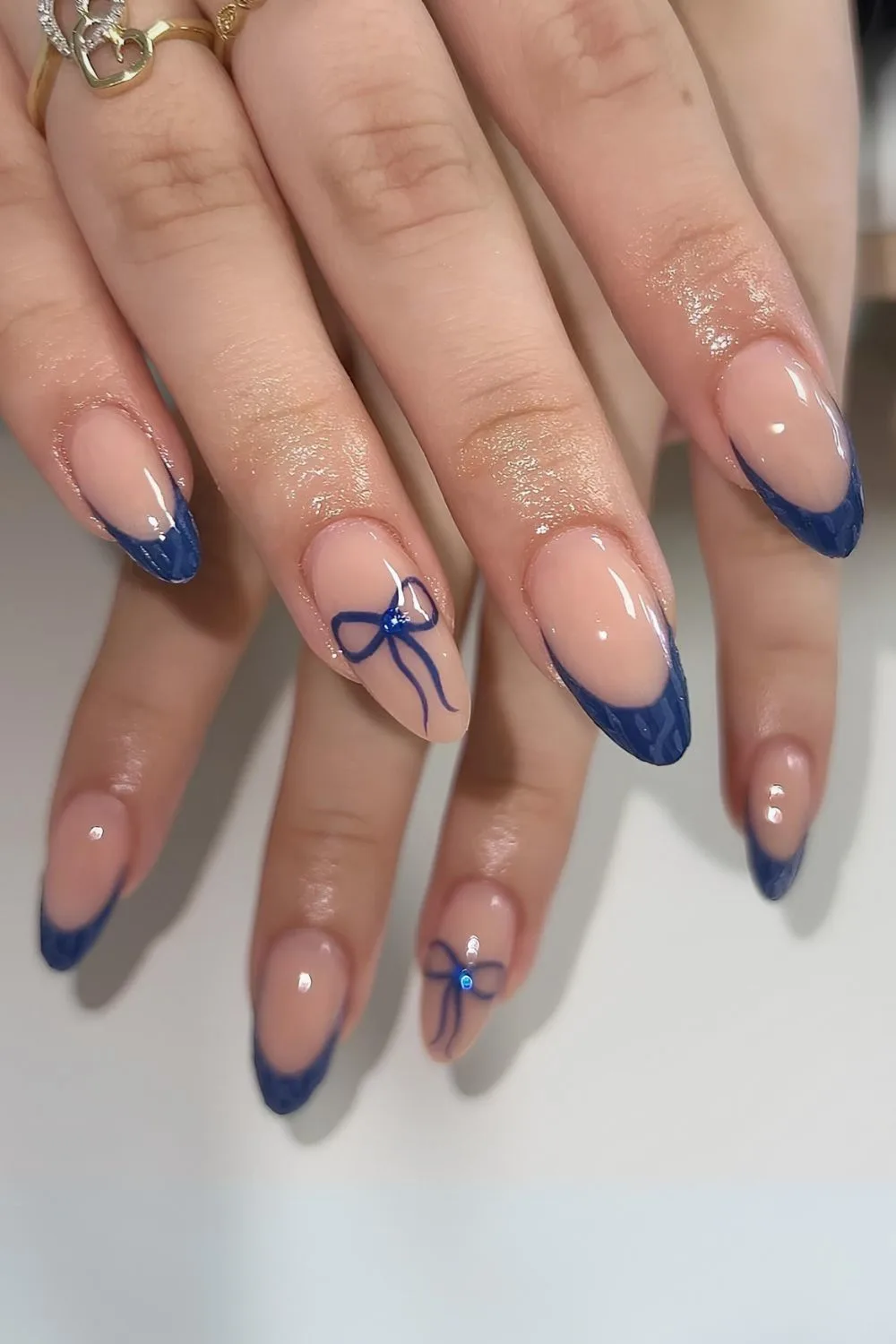 Navy French nails with bows and sweater pattern art