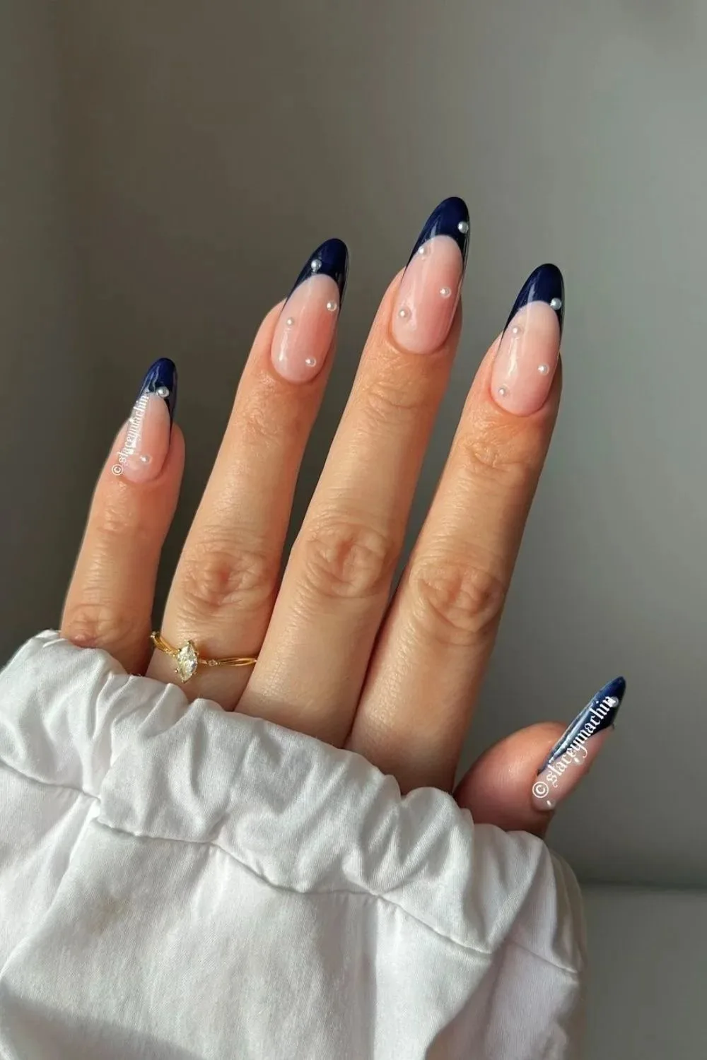 Navy French tip nails with pearl accents