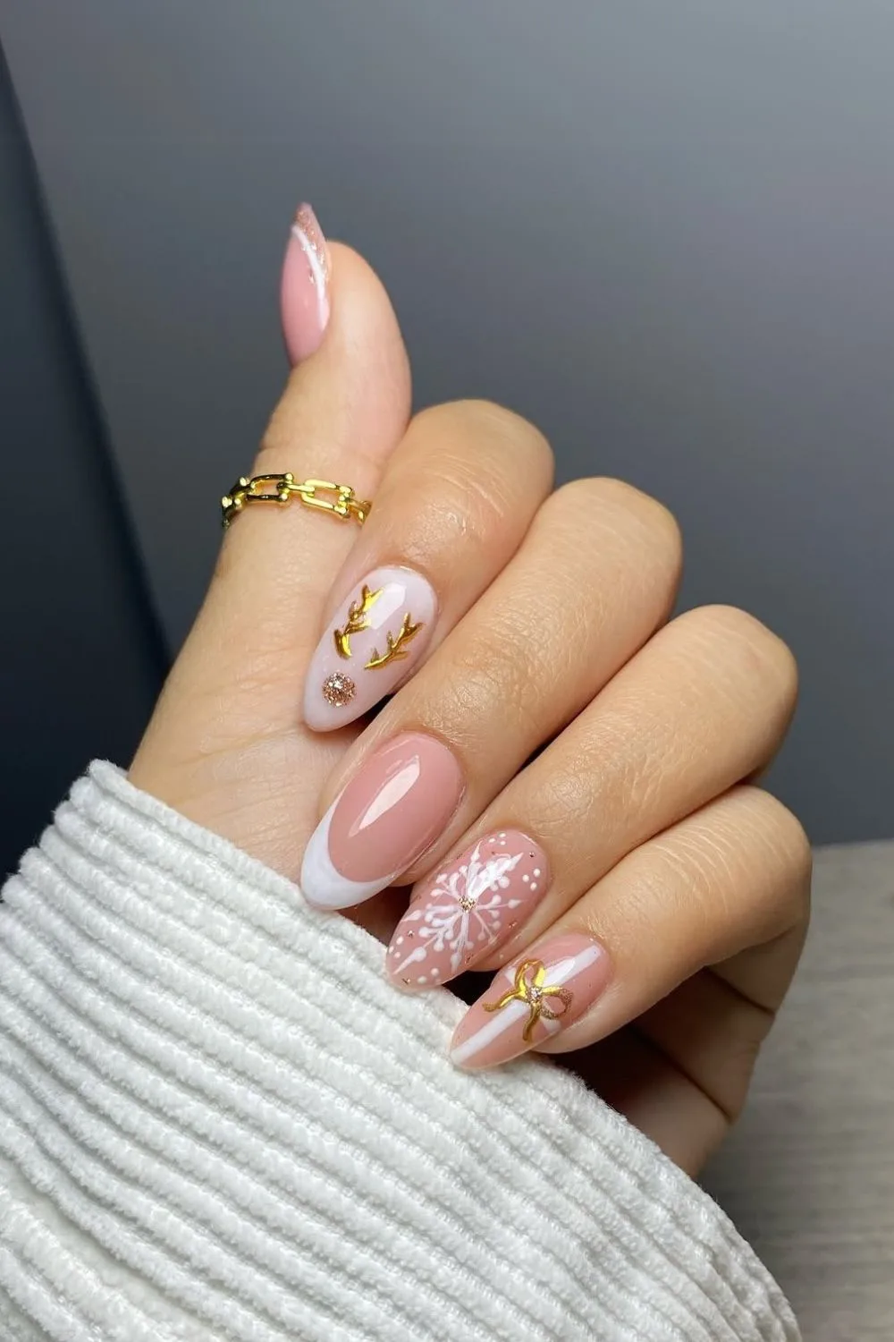 Nude and white nails with gold Christmas accents