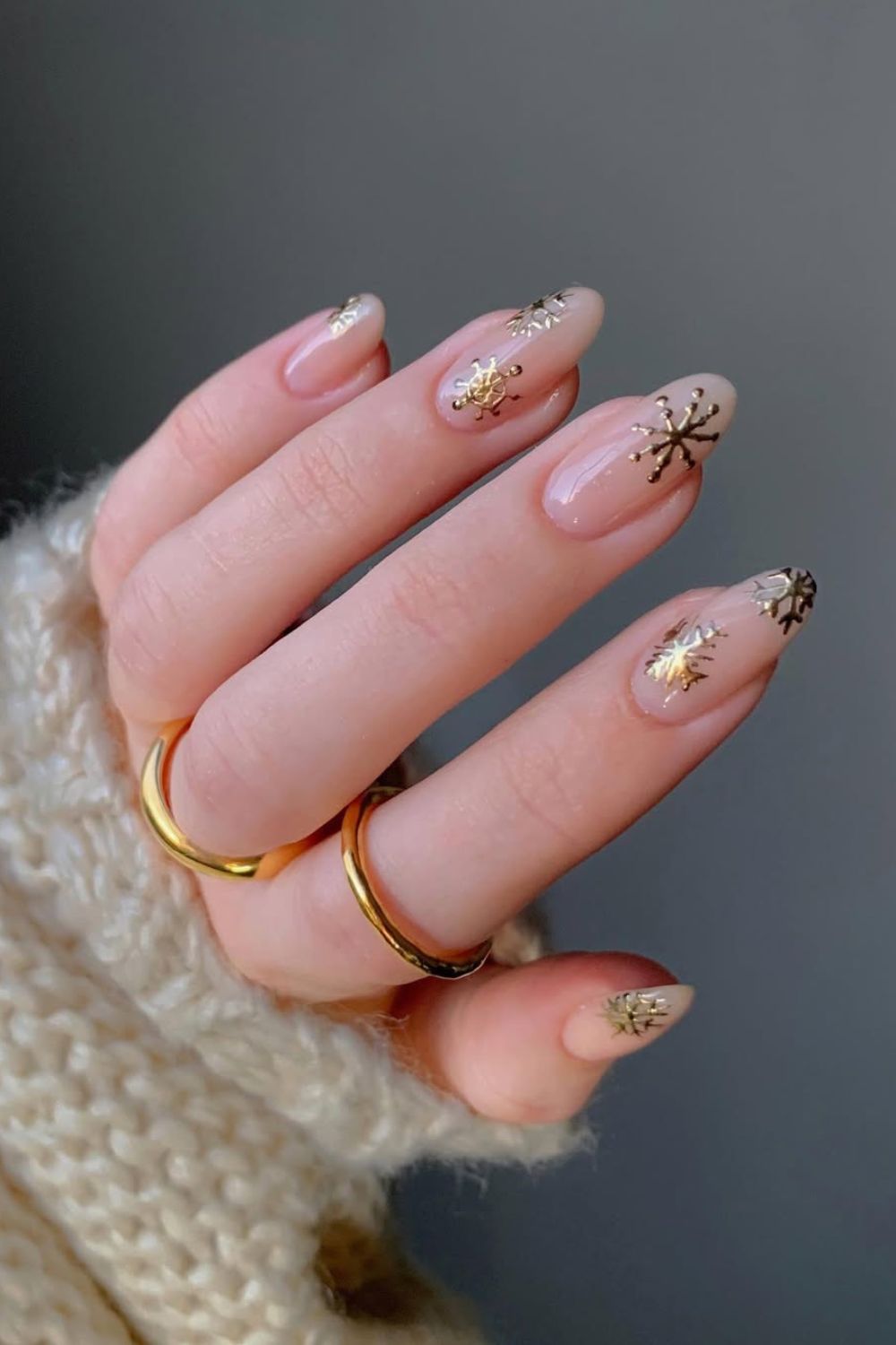 Nude nails wih gold snowflake design