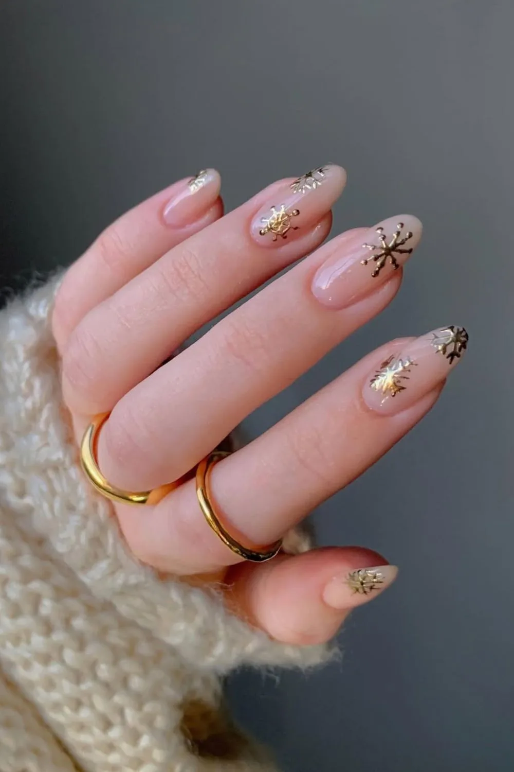 https://thepinkissue.com/wp-content/uploads/2024/12/Nude-nails-wih-gold-snowflake-design.jpg.webp?utm_source=chatgpt.com