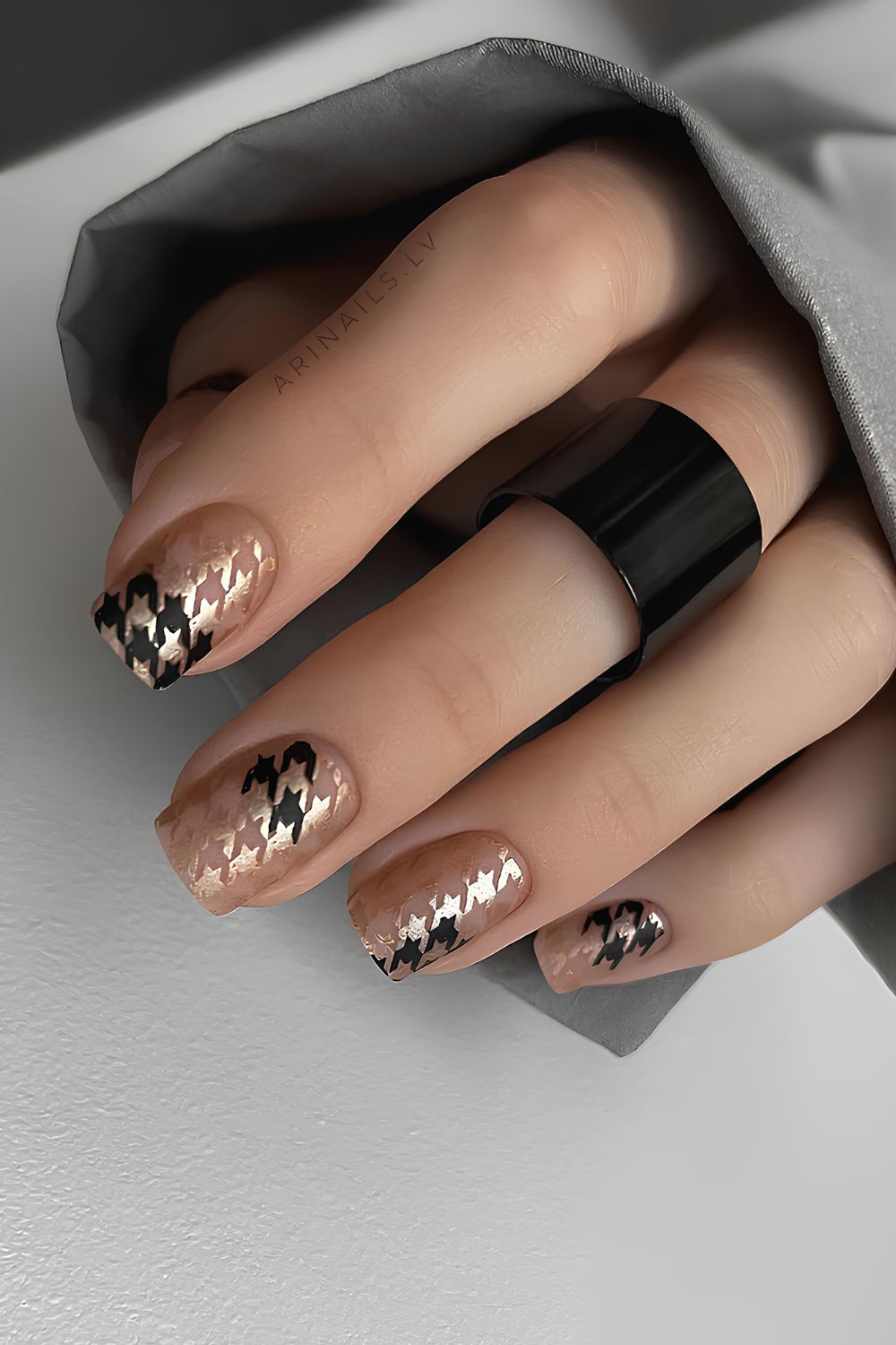 Nude nails with black and gold houndstooth accent art