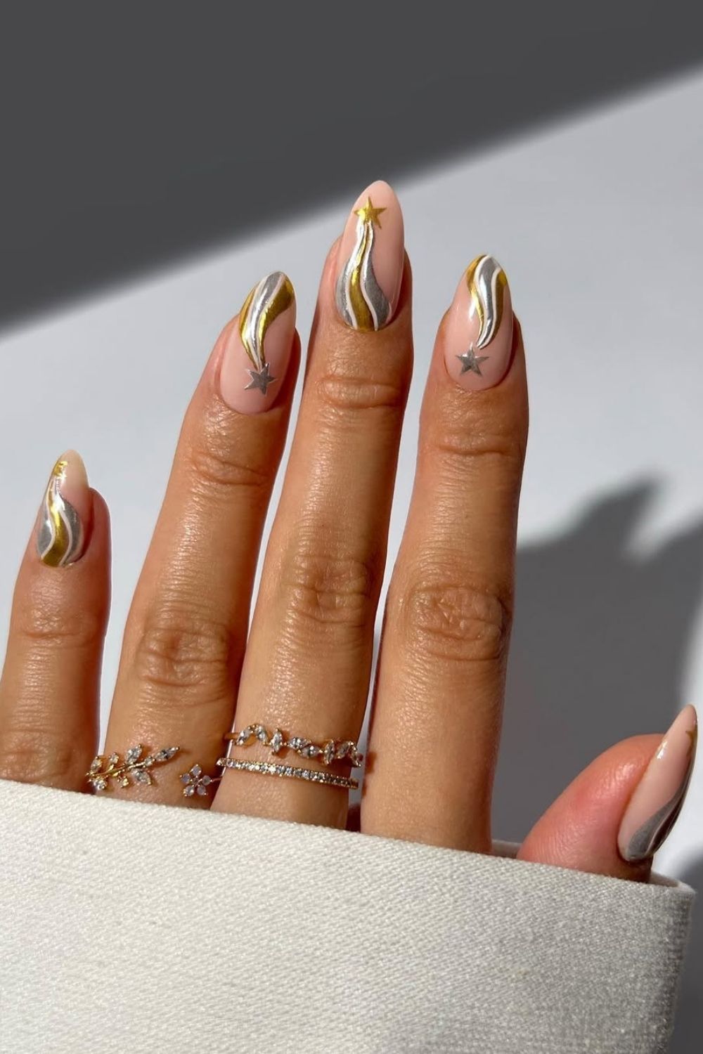 Nude nails with gold and silver star accents