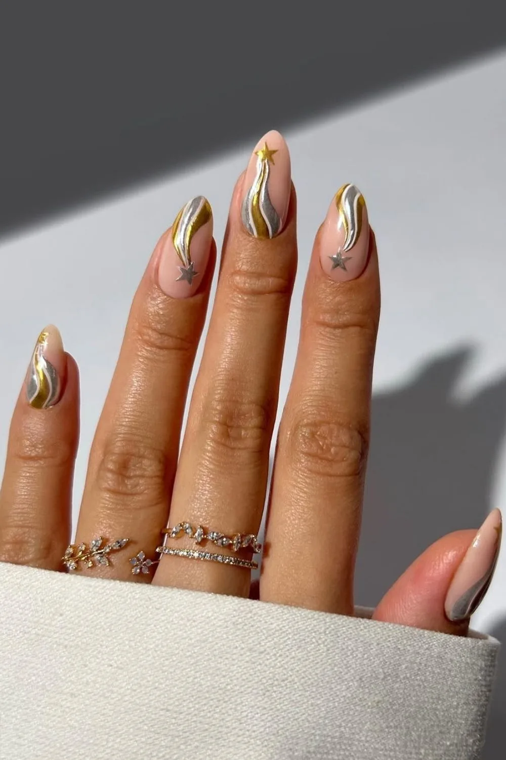 Nude nails with gold and silver star accents