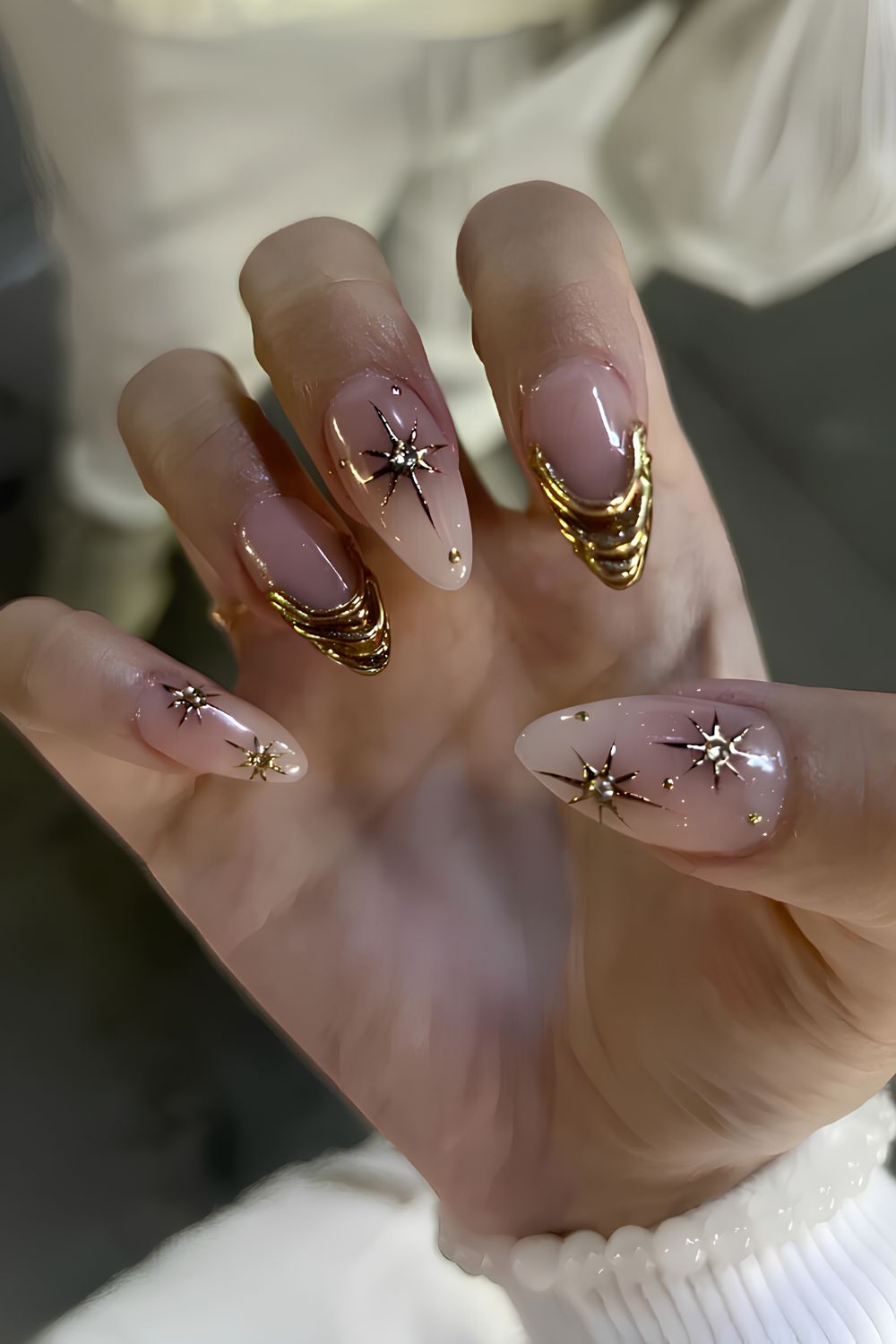 Nude nails with gold chrome celestial accents