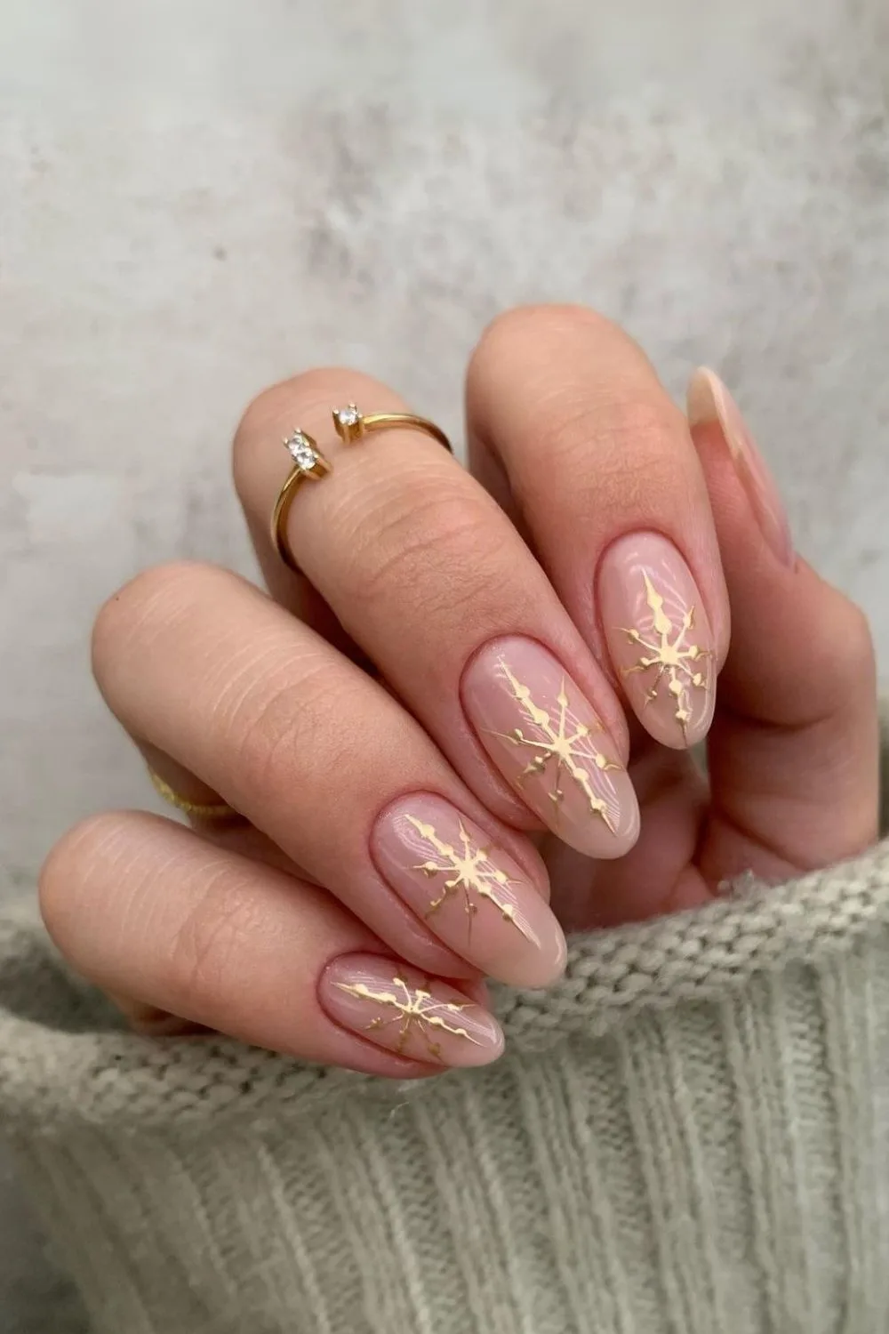 Nude nails with gold chrome snowflakes