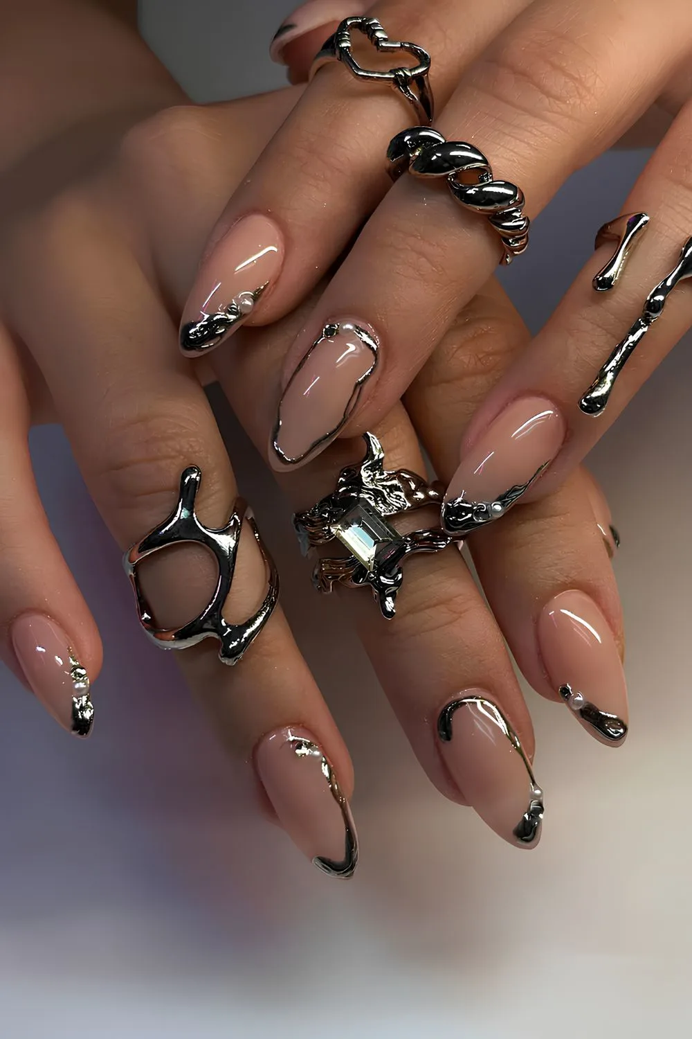 Nude nails with metallic silver abstract accents