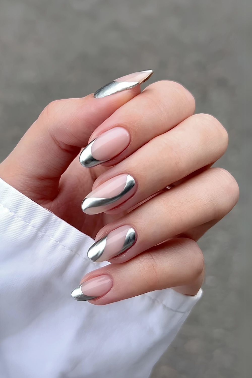 Nude nails with silver chrome siwrls