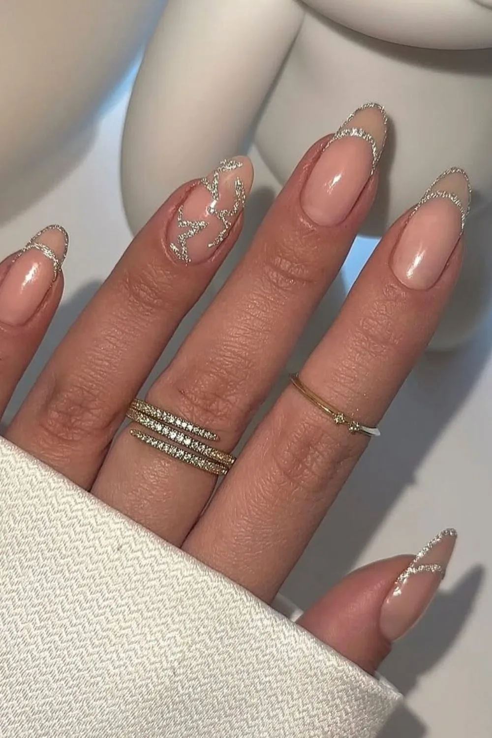 Nude nails with silver star accents